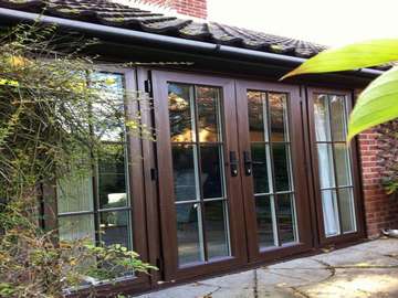Hollywell, North Wales : Installation of our 2500 Rosewood PvcU Chamfered framed french doors complete with 16mm Astragal bar to match the original doors. 